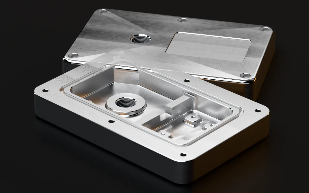 Rendering eines Beispielteils: zwei Gehäusedeckel aus Aluminium, blank gefräst, vorn die Innenseite mit Dichtfläche, O-Ring-Nut und Kammern